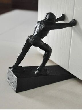 cast iron "Strong Man" door stopper, rustic design to securely hold doors open
